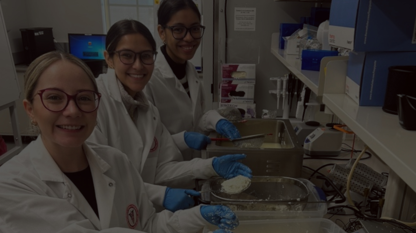 3 students smiling in microbiology lab